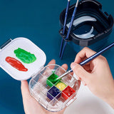 Fuumuui Multifunktionaler, faltbarer Pinselwascheimer mit einem Künstler, der mit Fuumuui-Kunstpinseln und einer durchsichtigen Farbpalette malt.