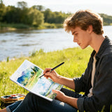 Young artist painting a vibrant landscape in a Fuumuui 7.6×7.6" Cold-Press 100% Cotton Watercolor Book, demonstrating Fuumuui Art Supplies' quality outdoors by a river.