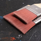 Close-up of two Fuumuui large nylon flat brushes, ideal for watercolor, acrylic, and oil painting, featuring soft reddish-brown bristles and metallic ferrules.