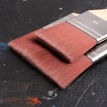 Close-up of two Fuumuui large nylon flat brushes, ideal for watercolor, acrylic, and oil painting, featuring soft reddish-brown bristles and metallic ferrules.