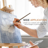 Fuumuui professional natural badger hair oil paint brush set used by an artist for textured acrylic canvas painting.