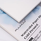 Fuumuui Watercolor Block 7x10 100% Cotton Cold Press art paper. Close-up of the textured white block surface and packaging.