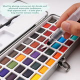 Set di acquerelli portatile a 50 colori Fuumuui con una mano che attiva una vivace cialda rossa utilizzando un pennello ad acqua, che mostra i colori solidi ad alta pigmentazione nella sua custodia da viaggio in metallo.