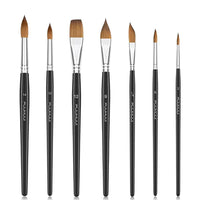 The complete 7-piece set is shown standing upright in a row, emphasizing the variety of shapes and sizes included, from fine-pointed rounds to a wide flat brush.