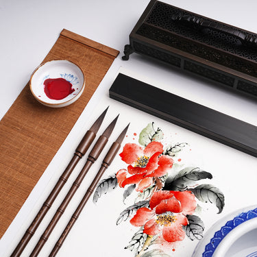 Fuumuui Professional Calligraphy Brushes with bamboo sections, suitable for watercolor, displayed alongside a vibrant red floral painting and red ink.