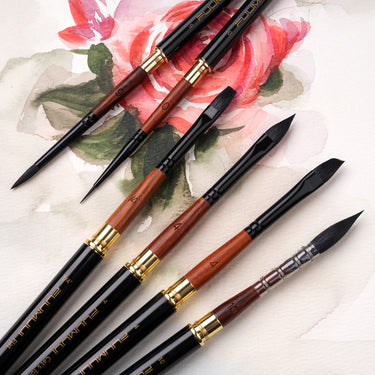 Fuumuui 6pcs high-grade pure squirrel hair travel watercolor brush set with various shapes including round, flat, and wash, featuring black and wood handles with gold ferrules, laid on watercolor paper.