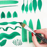 Fuumuui professional watercolor brush in action, painting diverse green strokes and leaf shapes on paper, demonstrating the versatility of Fuumuui 7pcs professional watercolor brushes.