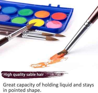 Fuumuui Watercolor Kit with vibrant paint set and high-quality sable hair brushes, one actively painting an orange stroke, demonstrating excellent liquid retention and pointed shape for artists.