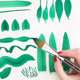 Set di 7 pennelli professionali per acquerello Fuumuui che crea diversi tratti verdi, linee e forme di foglie su carta bianca, dimostrando la versatilit¨¤ del set.
