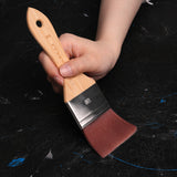 Fuumuui 50mm large nylon flat brush with bamboo handle, held by a hand, perfect for watercolor, acrylic, and oil painting art supplies.