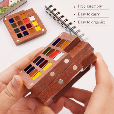 Set di acquerelli in legno premium Fuumuui con 15 colori selezionati a mano e tavolozza di miscelazione integrata, tenuto per mostrare il suo design compatto e portatile.