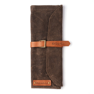 Fuumuui brown waxed canvas brush roll with durable leather strap closure and "Art Starts To Here" detail.
