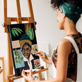 Artist painting a detailed portrait with Fuumuui professional watercolor brushes on an easel.