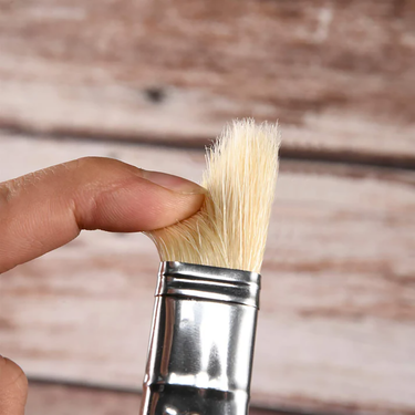 Fuumuui professional natural hog bristles paint brush close-up, hand pressing bristles to showcase texture.