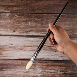 Fuumuui professional natural hog bristles paint brush held by hand, from the 11pcs set.