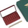 Fuumuui 24-well aluminum paint palette in burgundy red with metallic travel brush and box.