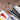 Four FUUMUUI watercolor paintbrushes displayed with ROCKWELL paint tubes and paper on a wooden surface.