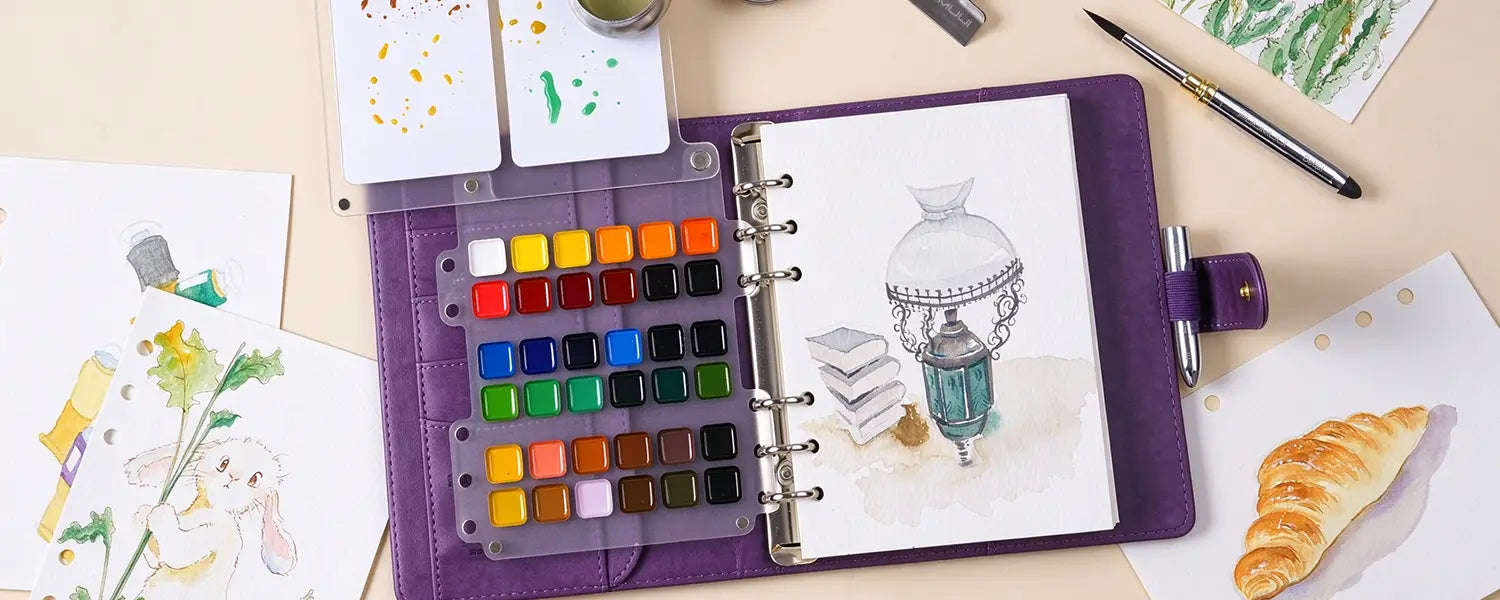 Overhead view of Fuumuui purple large watercolor travel sketchbook set open with painted sketches and watercolor grid.