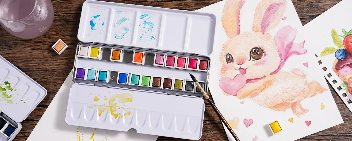 Flat lay of an open FUUMUUI metallic solid watercolor paint set palette next to a cute bunny painting.