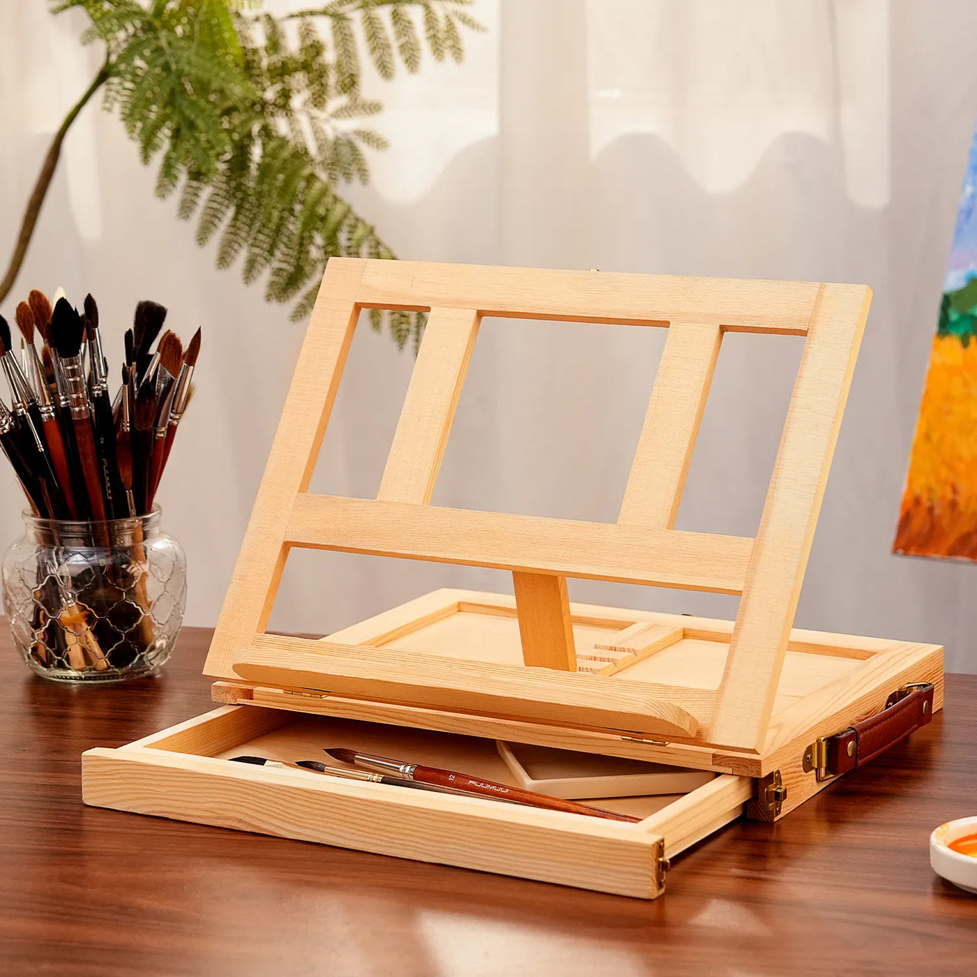 Adjustable wooden tabletop easel and sketchbox with storage drawer for professional artists. Includes Fuumuui watercolor brushes with Kolinsky sable hair and a ceramic palette for acrylic, oil, and gouache painting.