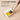 Paintbrush activating a semi-solid pigment pan in the Sunlit Yellow Creamora watercolor set.