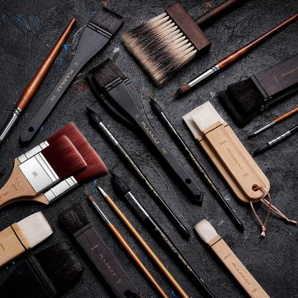 Variety of Fuumuui professional artist brushes featuring Squirrel Hair mop brushes, synthetic nylon flats, and Extended Point detail brushes in individual sizes for watercolor, oil, and acrylic paint.