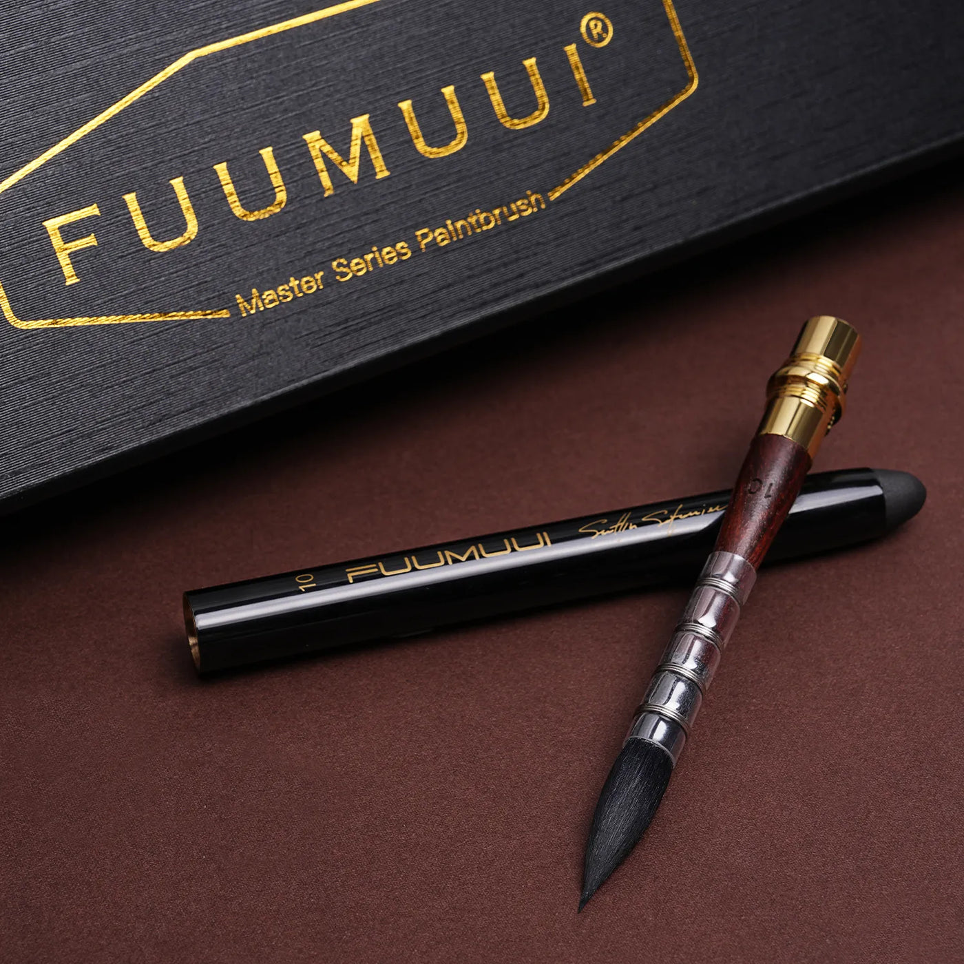 Fuumuui Master Series Size 10 limited edition travel watercolor brush with squirrel hair and quill binding. Professional artist travel pocket brush for watercolor painting, featuring a black handle and gold accents.