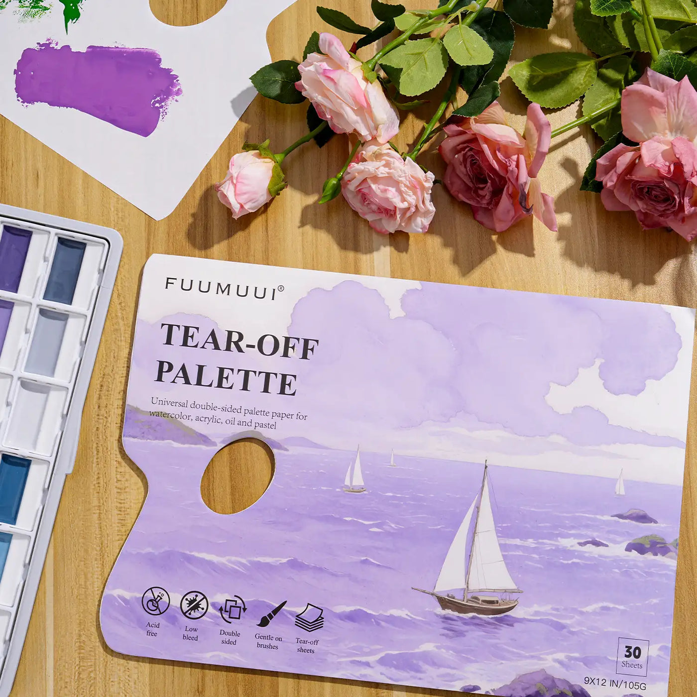Fuumuui 9x12 Tear-Off Palette Paper for watercolor, acrylic, and oil paint. 30 acid-free, double-sided 105g sheets gentle on brushes, shown with a watercolor paint set and purple pigment for professional artists.