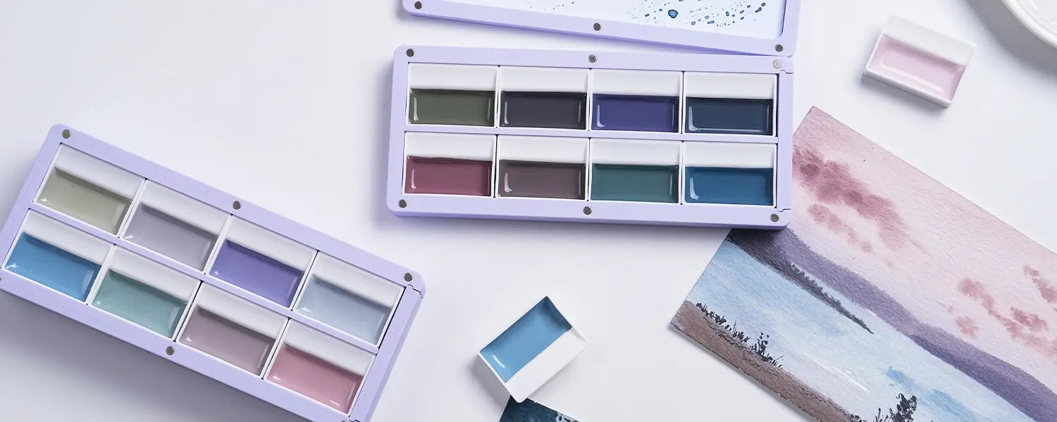 FUUMUUI 3-Layer Magnetic Palettes with muted paints, alongside a watercolor landscape painting.