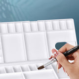 Fuumuui Watercolor Palette Folding Paint Tray Plastic Painting Pallet with 31 Compartments, Thumbhole and Brush Holders, White