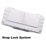 Palette d'aquarelle Fuumuui avec système de verrouillage à clip, ouverte et montrant des godets de mélange blancs.