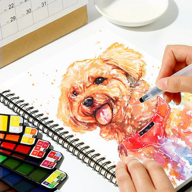 Fuumuui Travel Portable Watercolor Set Assorted Colors Pocket Kit in use, with an artist painting a vibrant dog portrait on a sketchbook using a water brush pen.